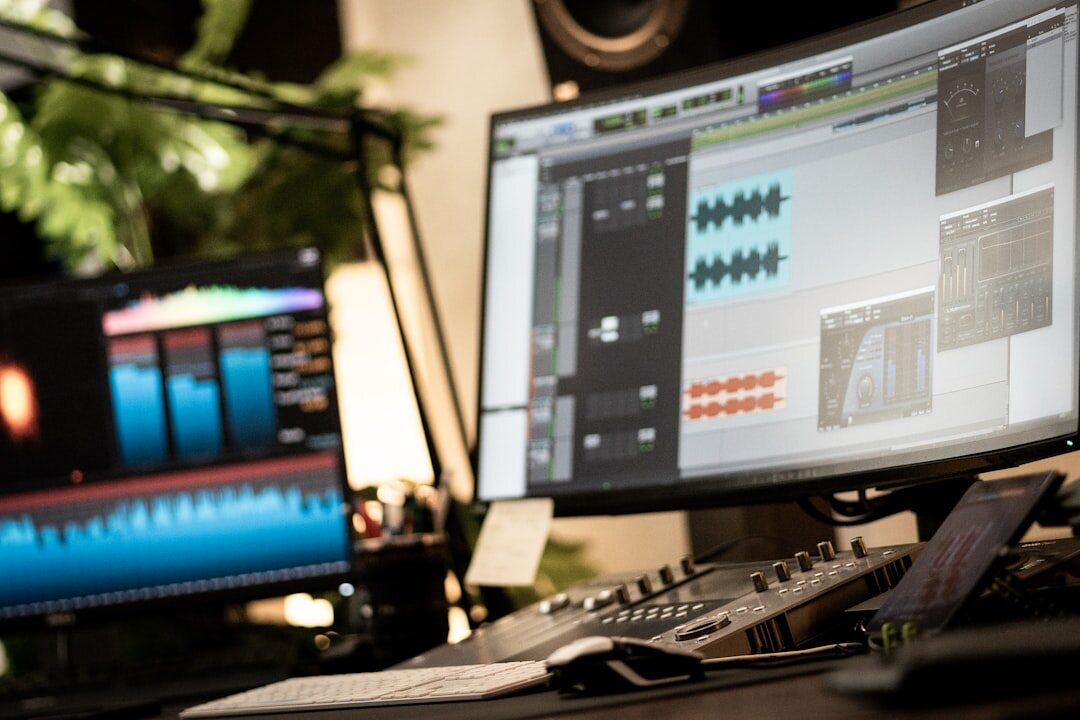 Colour grading workstation with a calibrated reference monitor showing a graded film frame